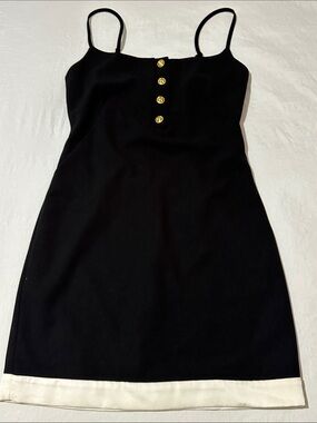 Gill Judith Elegant Black Mini Dress with White Hem and Gold Button Detail